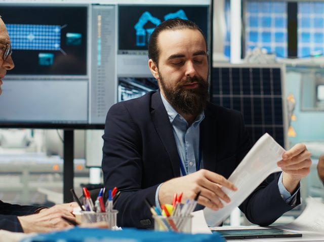 Factory executives meet with investors to discuss automating production