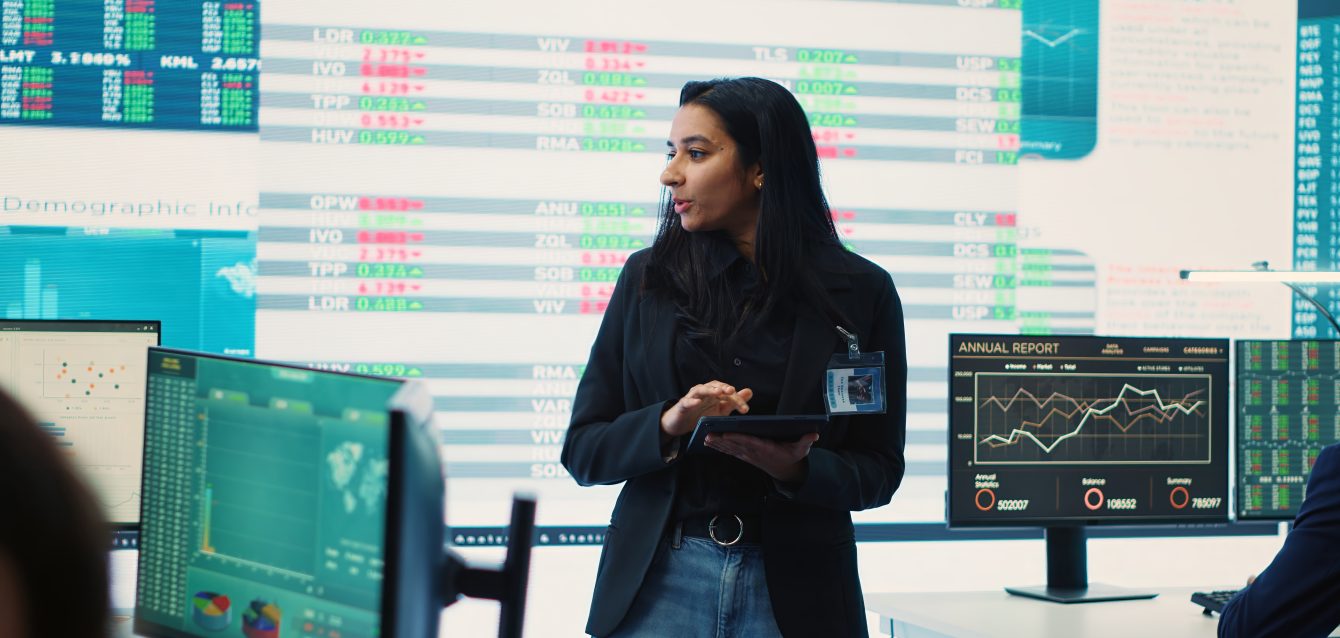 Enterprise manager looking into project updates and details in monitoring room Enterprise manager looking into project updates and details in monitoring room