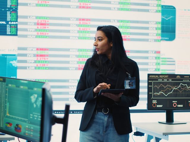 Enterprise manager looking into project updates and details in monitoring room