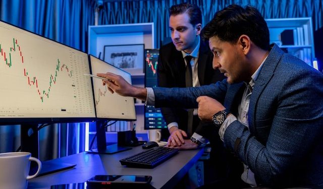 stock-exchange-traders-looking-high-profit-chart-investment-panorama-view-analyzing-monitor-night-concept-discussing-financial-technology-growth-neon-light-workplace-sellable_31965-335772