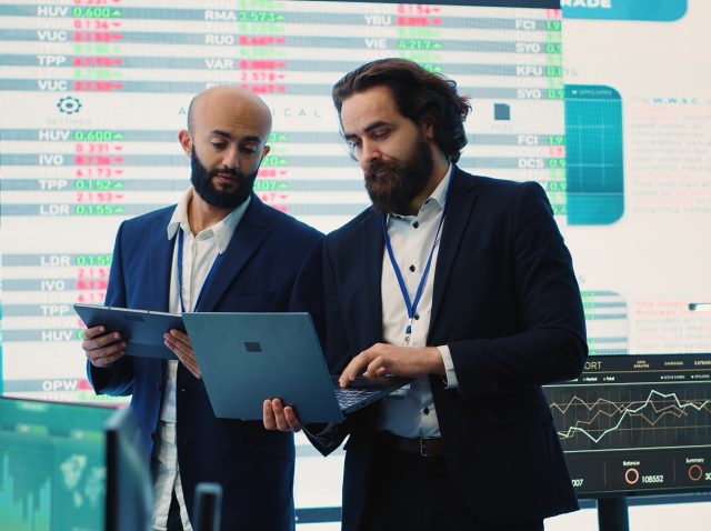 Team of investors analyzing profit amount and making decisions